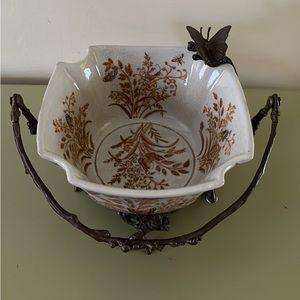 Butterfly decorative bowl with cast iron base, handle and one perched butterfly.